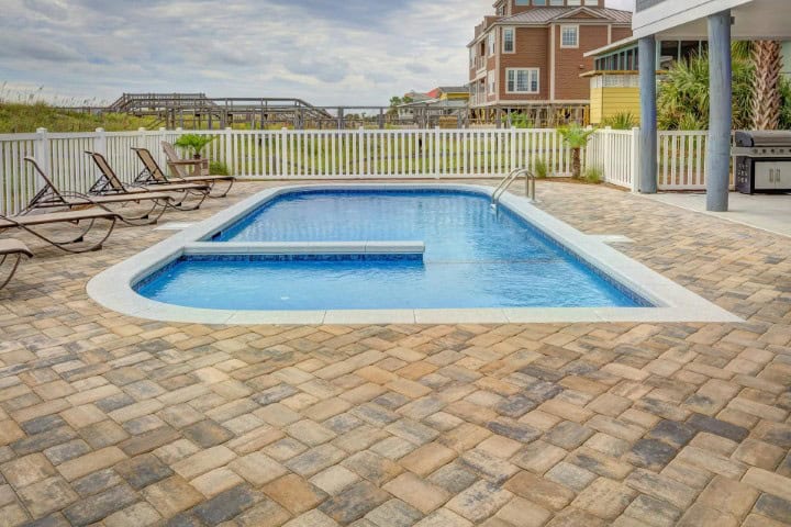 Spacious backyard with a pool and outdoor lounge area